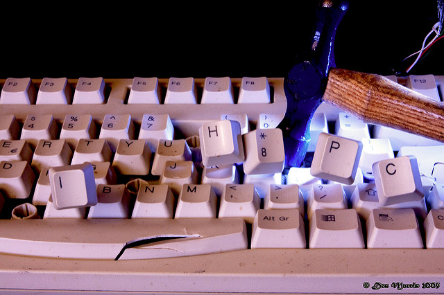 A hammer smashing a keyboard and the letters