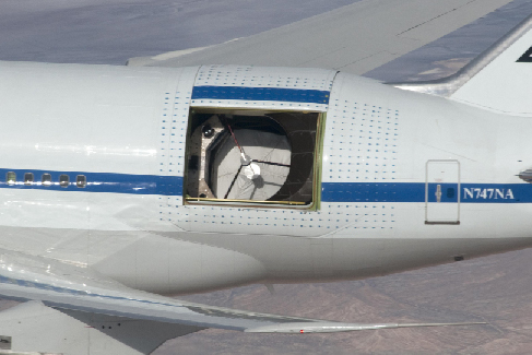 Image of the interior of the SOFIA aircraft, showing the massive telescope and supporting instruments that fill a substantial portion of the cabin.
